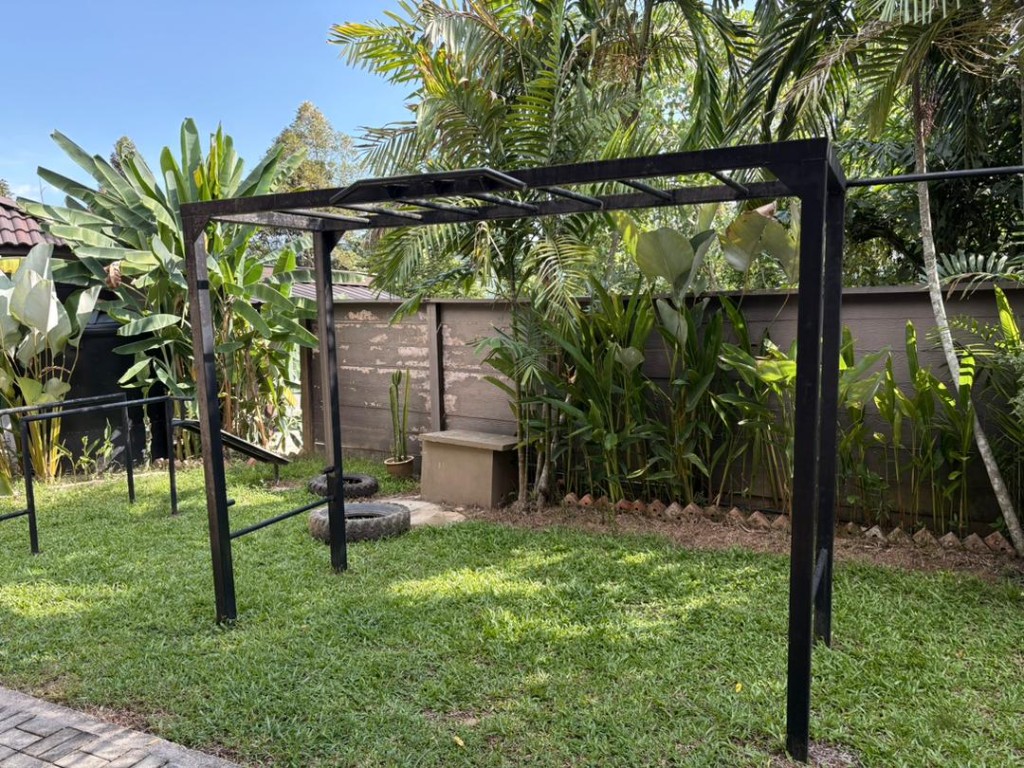 Outdoor crossfit pull-up rig with tyres on the lawn at Bambu