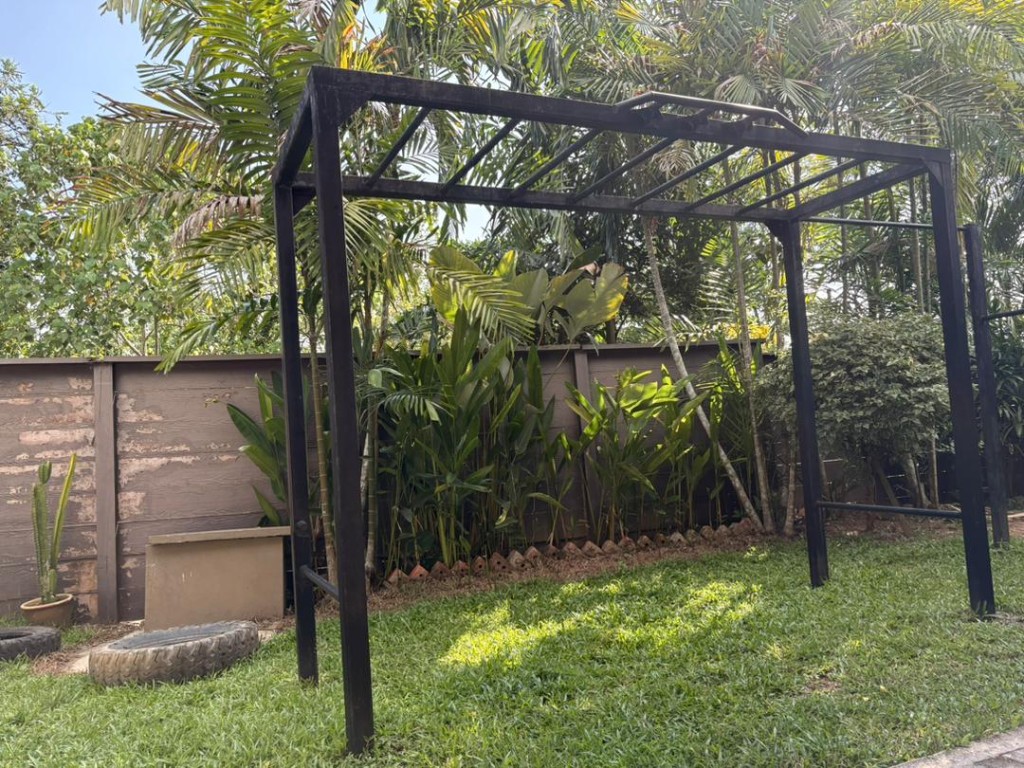 Side angle of the Bambu outdoor calisthenics rig in the garden