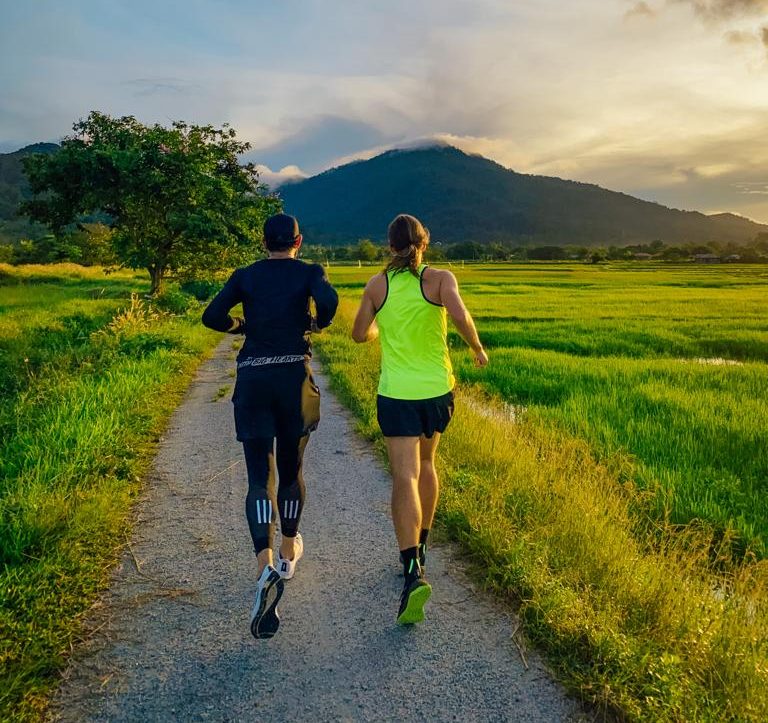 Trail running through rice fields and tropical jungle near Bambu